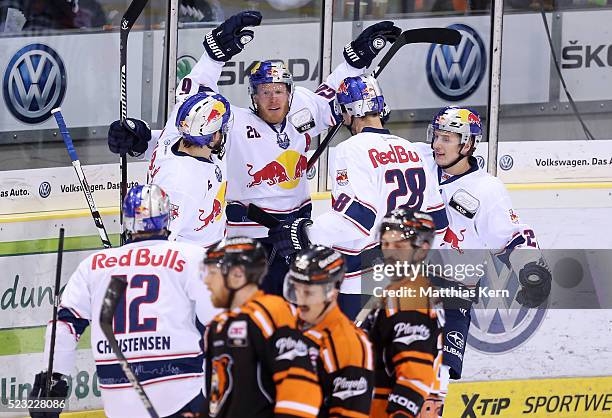 Toni Soederholm of Muenchen jubilates with team mates after scoring his teams first goal during the DEL playoffs final game four between Grizzlys...