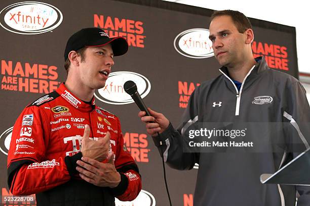 Brad Keselowski, driver of the Thomas Built Buses Ford, speaks with media and students at Richmond International Raceway on April 22, 2016 in...