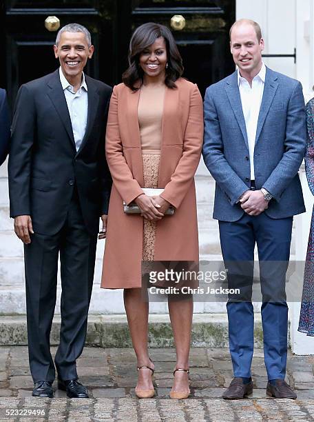 President Barack Obama, First Lady Michelle Obama and Prince William, Duke of Cambridge pose as they attend a dinner at Kensington Palace on April...