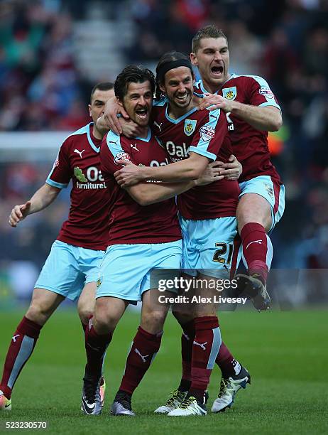 Joey Barton of Burnley celebrates with George Boyd and Sam Vokes after his deflected free kick goes in for the opening goal during the Sky Bet...