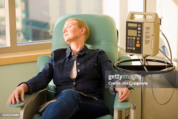 woman receiving chemotherapy treatment - receiving treatment concerned stock pictures, royalty-free photos & images