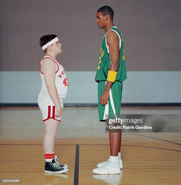 basketball player facing taller opponent - chubby teen boy stock pictures, royalty-free photos & images