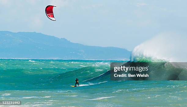 kitesurfer riding a big wave - kite toy foto e immagini stock