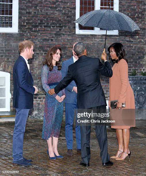 Catherine, Duchess of Cambridge, Prince Harry, First Lady Michelle Obama and US President Barack Obama greet each other as they attend a dinner at...