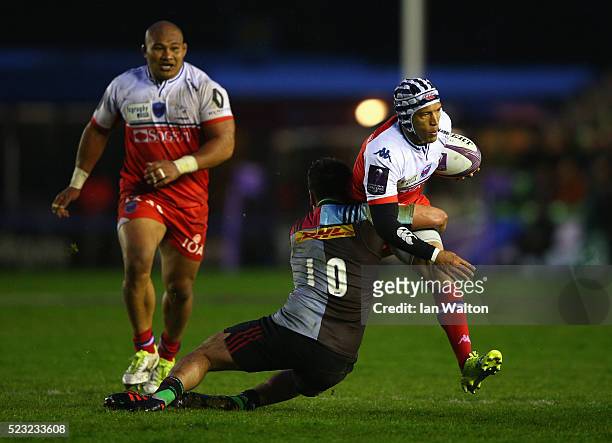 Gio Aplon of Grenoble is tackled by Ben Botica of Harlequins during the European Rugby Challenge Cup Semi Final match between Harlequins and Grenoble...