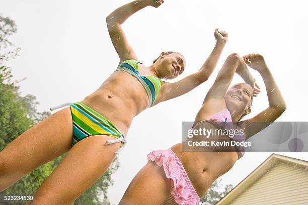 girls playing in the rain - young teen bathing suit stock pictures, royalty-free photos & images