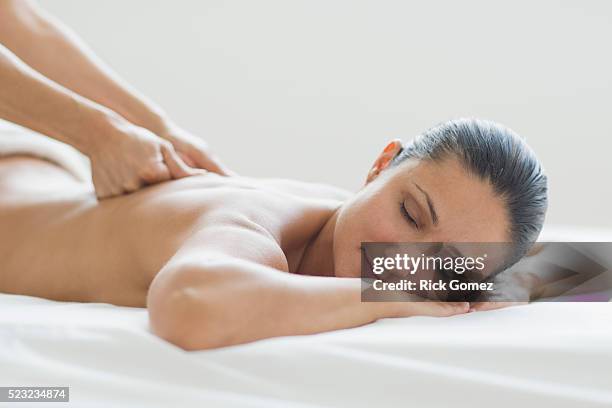 hands massaging woman's back - massage therapy stock pictures, royalty-free photos & images