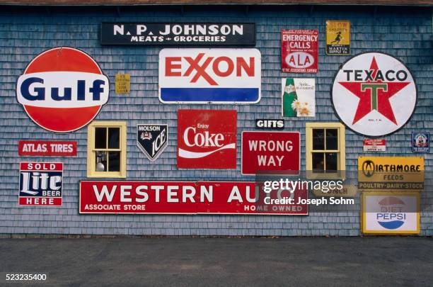 road signs on the "love barn" - exxon stock pictures, royalty-free photos & images
