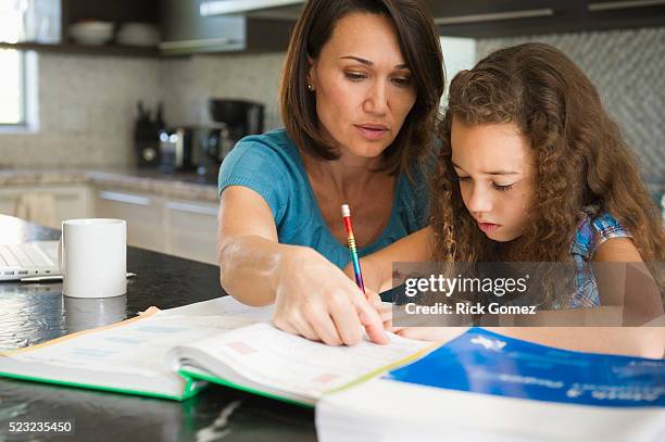 woman helping daughter with her studies - homeschooling stock pictures, royalty-free photos & images