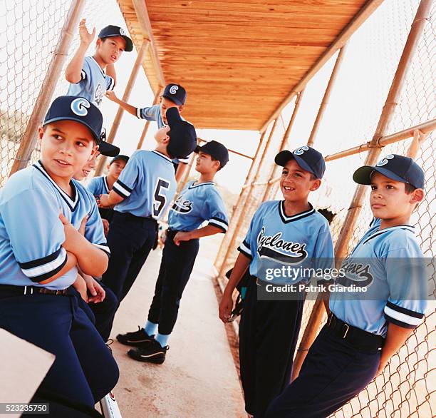 little league baseball team in dugout - youth sports league stock pictures, royalty-free photos & images