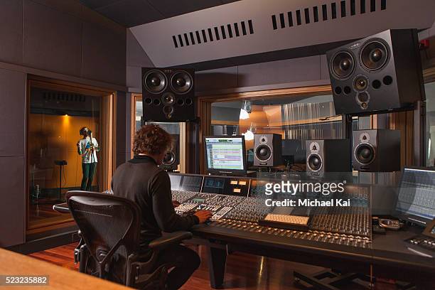 sound engineer using mixing desk - af studio stockfoto's en -beelden