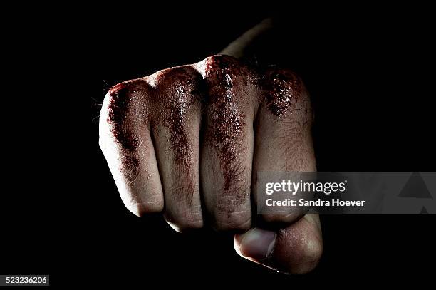 close up of boxer's fist covered with blood - vuist stockfoto's en -beelden