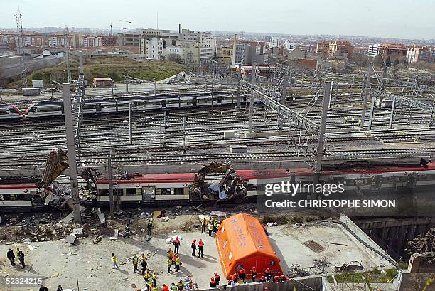 Bodies of victims are evacuated after a train exploded at the Atocha train station in Madrid 11 March 2004. Relatives of many of those killed in the...