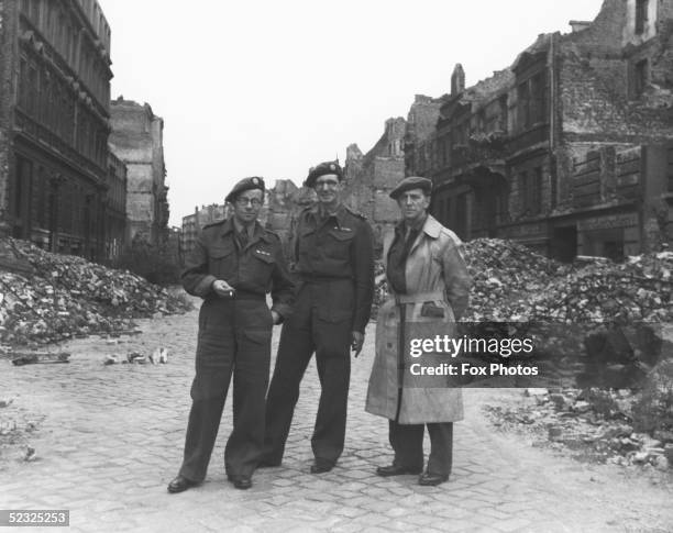 Allied servicemen pose in a street of wrecked buildings in post-war Hamburg, September 1945.