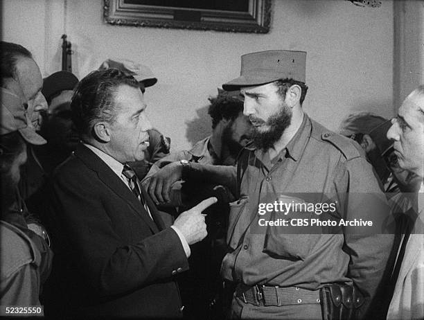 American variety show host Ed Sullivan interviews Cuban Communist leader and president Fidel Castro amid a group of uniformed revolutionaries on a...