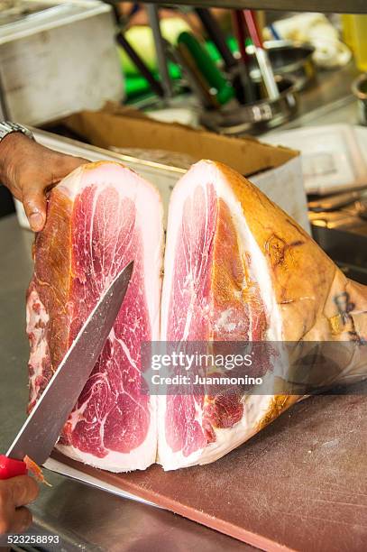 chef cutting a parma cured prosciutto - prosciutto stock pictures, royalty-free photos & images