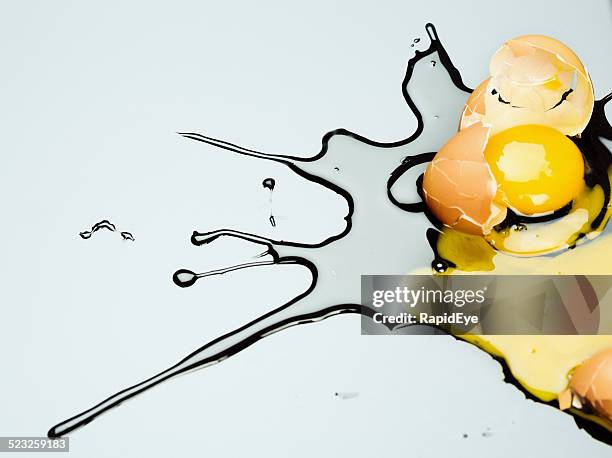 accident: broken egg splashing on gray perspex - raw acrylic stock pictures, royalty-free photos & images