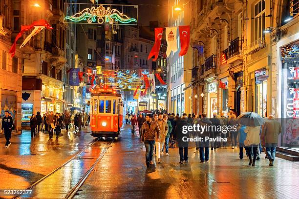 christmas lights, national flags and tramway in istanbul, turkey - istiklal avenue stock pictures, royalty-free photos & images