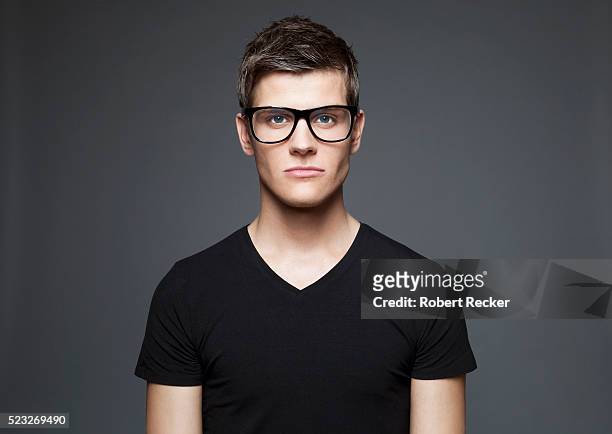 portrait of a young adult man - white/black shirt stock-fotos und bilder