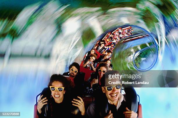 spiraling roller coaster - fahrgeschäft stock-fotos und bilder