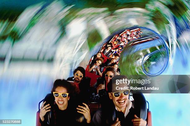 spiraling roller coaster - amusement ride stock pictures, royalty-free photos & images