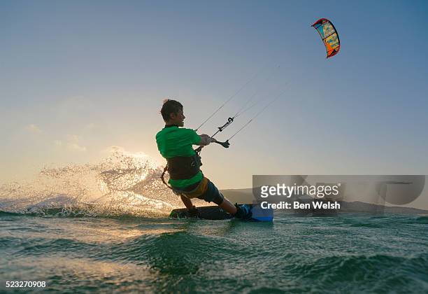view of young man kitesurfing, tarifa, costa de la luz, andalusia, spain - kite surfing stock pictures, royalty-free photos & images