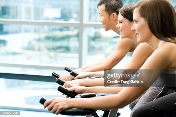 three friends are in a exercising class at a gym - surrey british columbia stock pictures, royalty-free photos & images