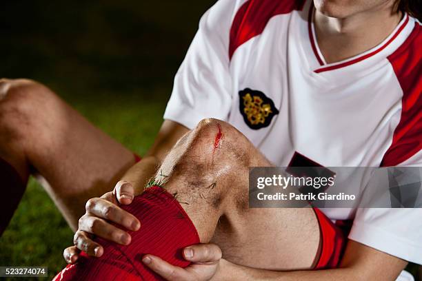 injured soccer player - soccer injury stock pictures, royalty-free photos & images