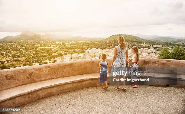 Family looking at mediterranean town of Pollenca, Mallorca.