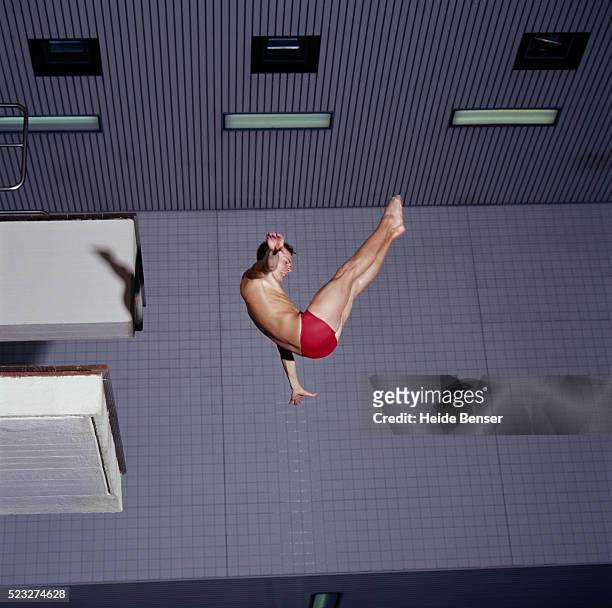 diver in mid-dive - sprungturm stock-fotos und bilder
