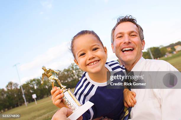 father and daughter with soccer trophy - child trophy stock-fotos und bilder