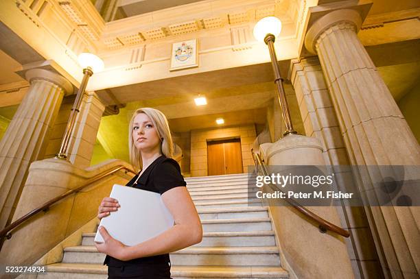 woman holding a laptop - lawyer woman stock pictures, royalty-free photos & images