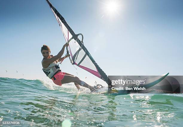 young woman windsurfing and having fun - wind surfing stock pictures, royalty-free photos & images