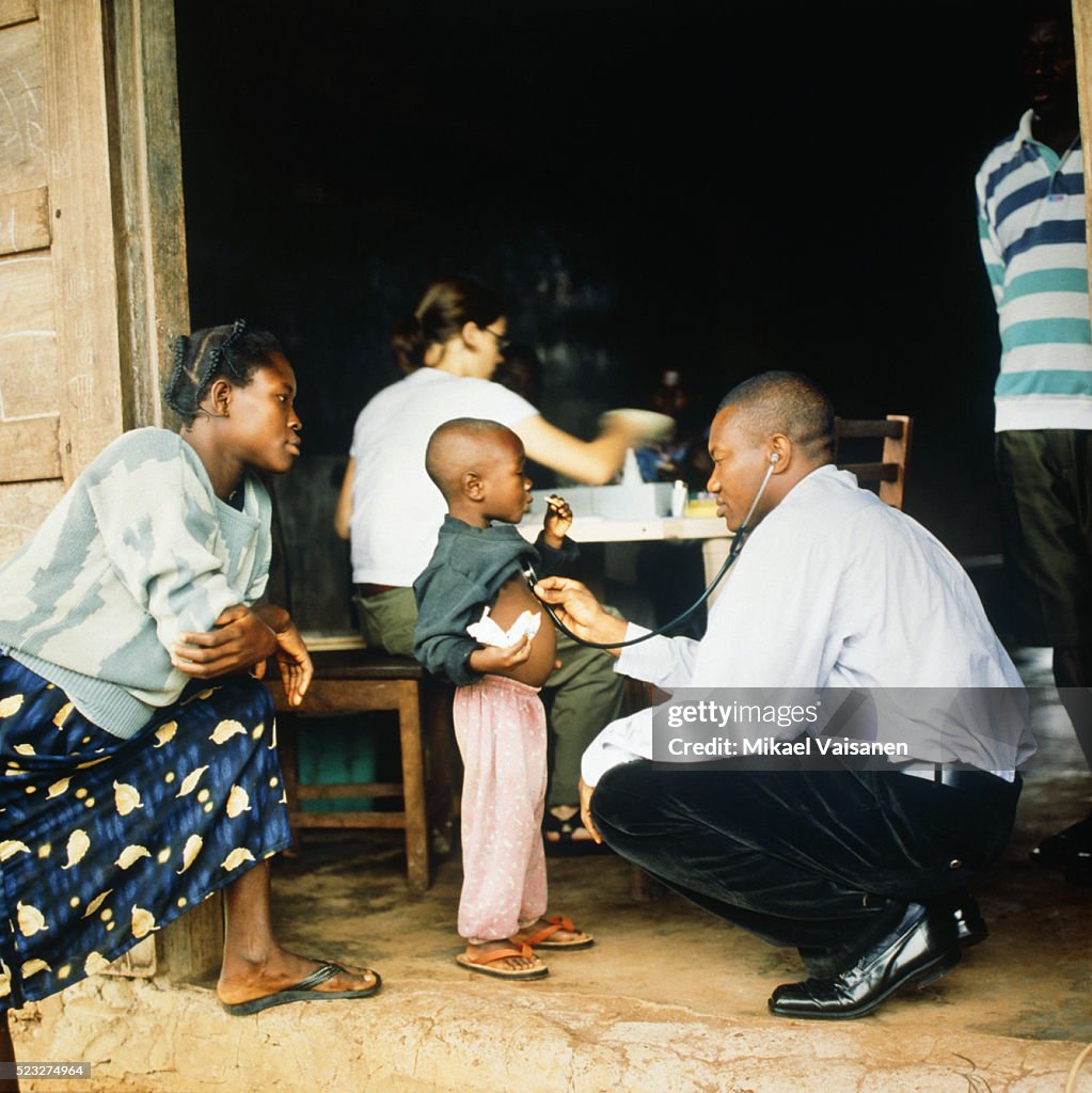 Doctor treating boy in Ghana