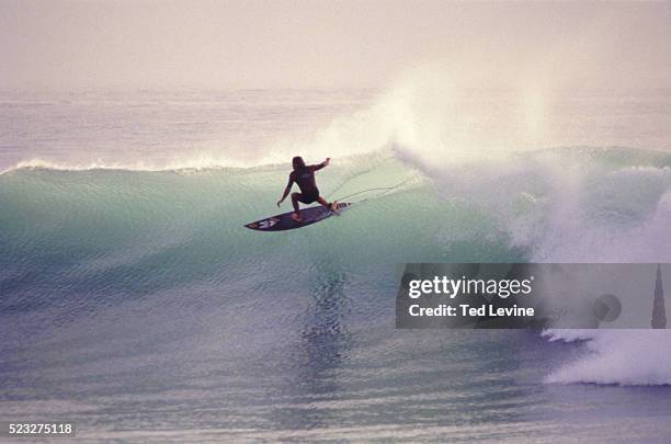 man crouching on surfboard, tarhazoute, morocco - surfer stock pictures, royalty-free photos & images