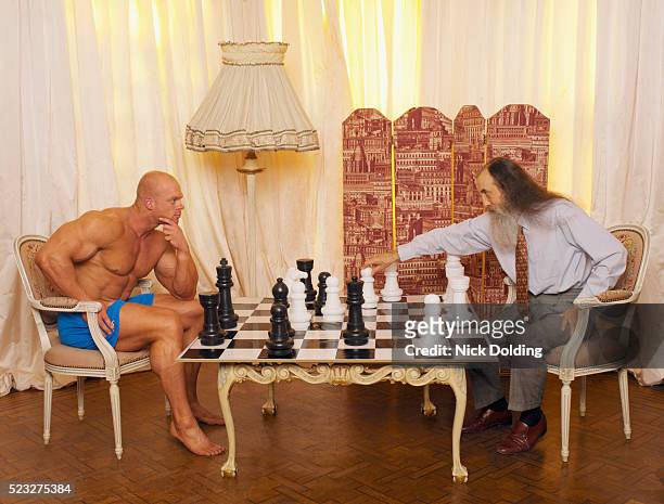 brains versus brawn - senior playing chess stock pictures, royalty-free photos & images