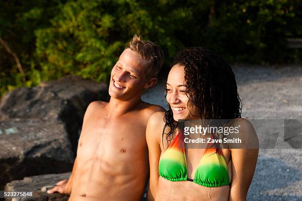 young couple sitting on riverbank, coatesville, pennsylvania, usa - coatesville stock pictures, royalty-free photos & images