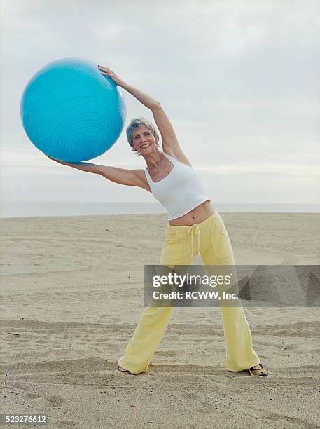 woman using exercise ball - yoga ball outside stock pictures, royalty-free photos & images