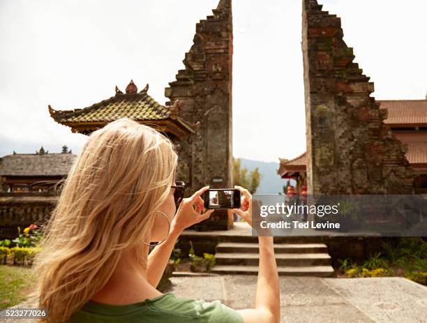 woman taking a picture of a temple - bali stock pictures, royalty-free photos & images