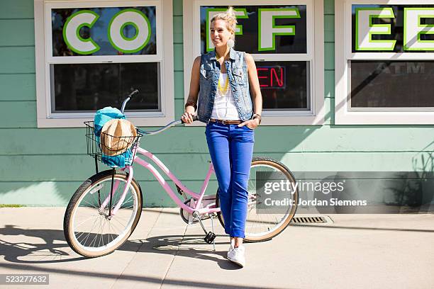 woman on a cruiser bike standing in front of a coffee shop, santa cruz, california, usa - santa leaning stock pictures, royalty-free photos & images