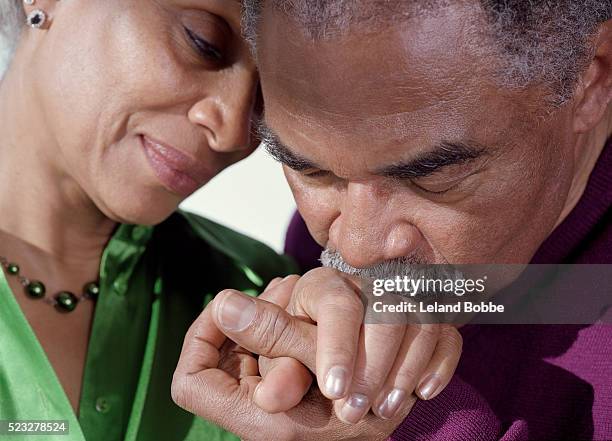 man kissing woman's hand - black people kissing stock pictures, royalty-free photos & images