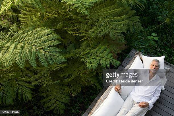 man relaxing outdoors - prosperity stock pictures, royalty-free photos & images