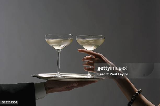 waiter serving champagne in elegant saucers - affluent dining stock pictures, royalty-free photos & images