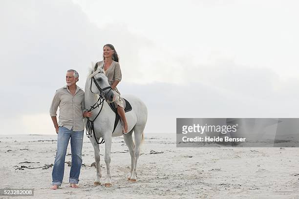 couple with horse - finding gray hair stock pictures, royalty-free photos & images