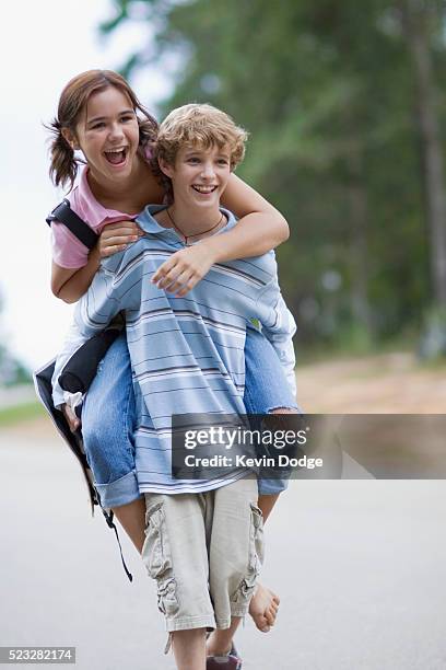 pre-teens piggyback ride - pre adolescent child bildbanksfoton och bilder