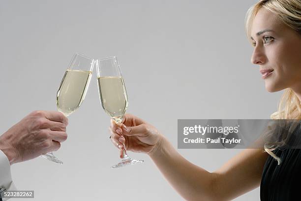 woman and man toasting with champagne - formalwear ストックフォトと画像