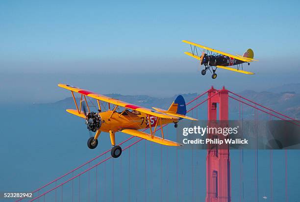 boeing-stearman n2s flying above golden gate - biplane stock pictures, royalty-free photos & images