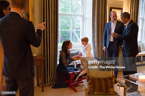 In this handout provided by The White House, President Barack Obama talks with the Prince William, Duke of Cambridge as Catherine, Duchess of...