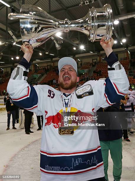 Maximilian Kastner of Muenchen poses with the trophy after winning the DEL playoffs final game four between Grizzlys Wolfsburg and Red Bull Muenchen...