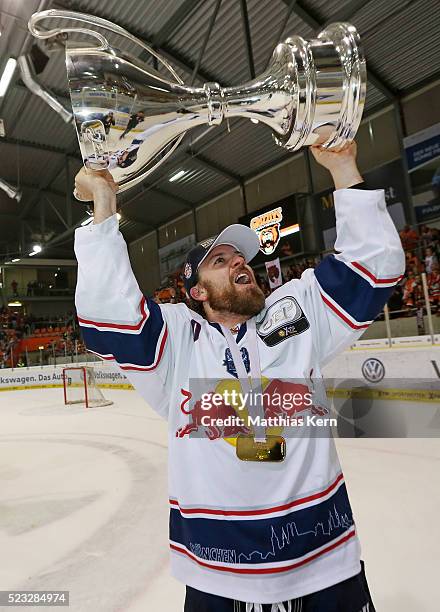 Daniel Sparre of Muenchen poses with the trophy after winning the DEL playoffs final game four between Grizzlys Wolfsburg and Red Bull Muenchen at...